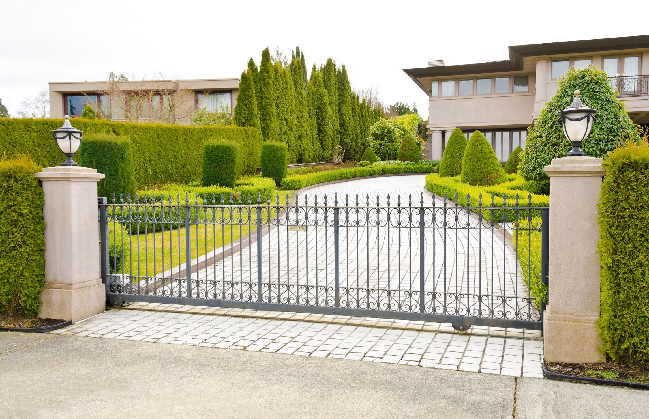 california home with iron gate in front of driveway