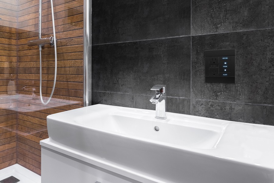 bathroom sink with an on-wall keypad above it that lets people control their whole-house audio system and smart home technologies.