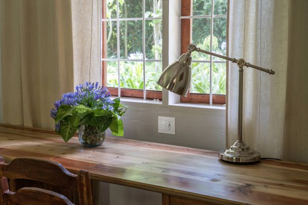 wooden desk in front of a window
