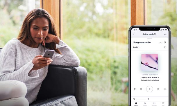 Crestron phone interface over an image of a woman playing on her phone