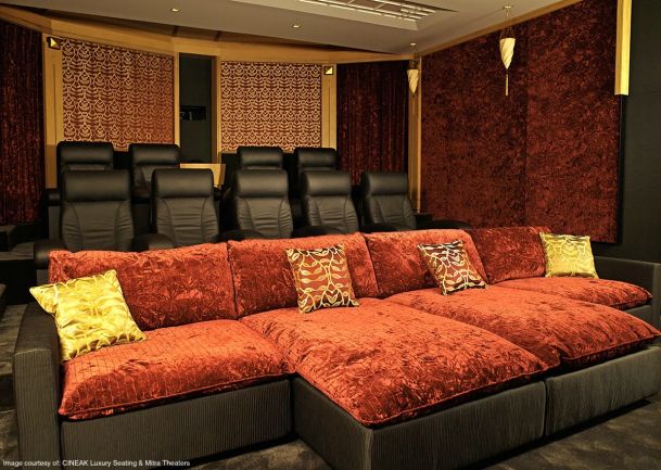 home theater with black seating and red velvet chairs
