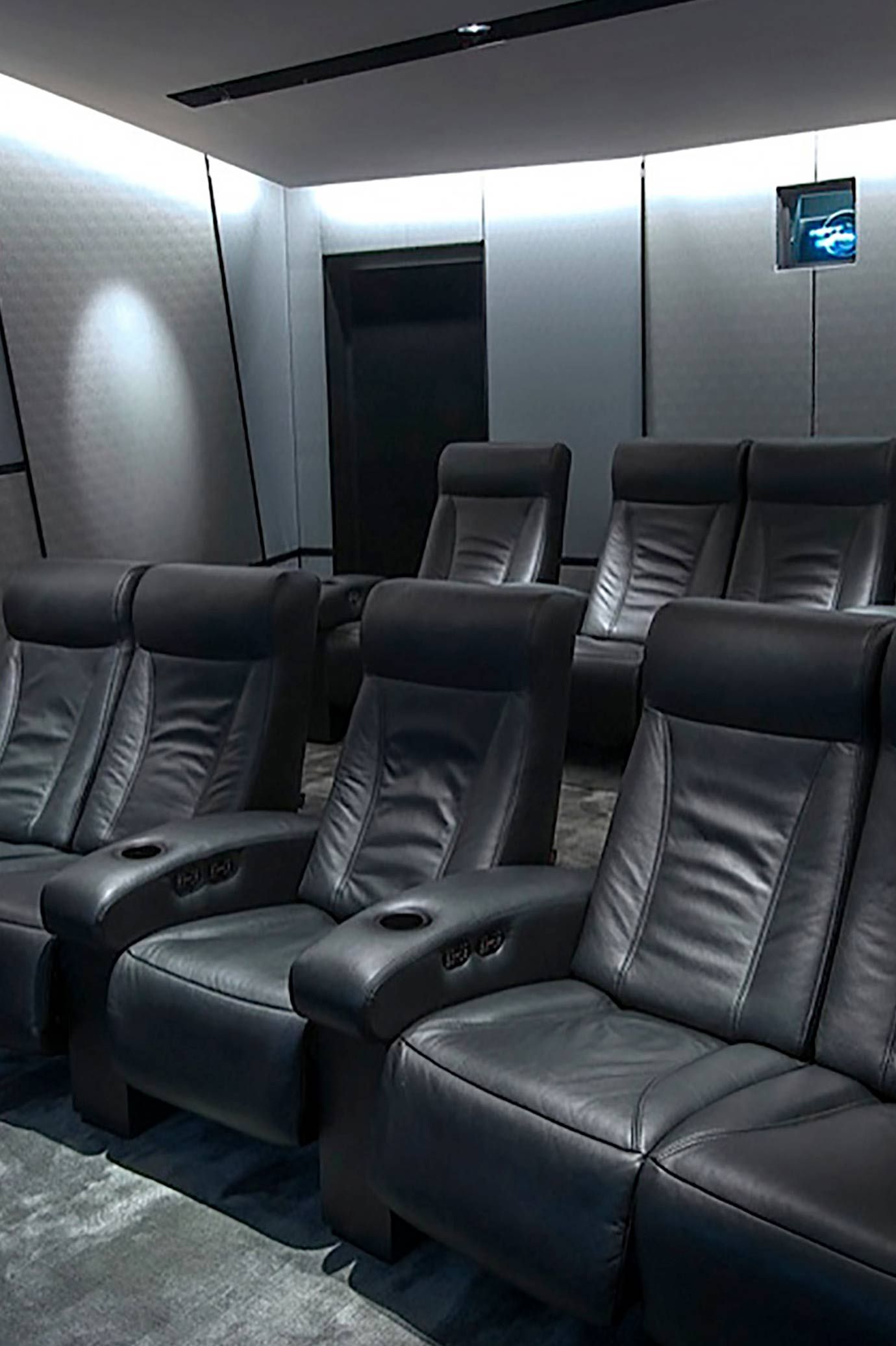 Custom Seating in a home theater, black leather chairs