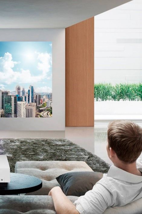 Man watching screen with cityscape on it