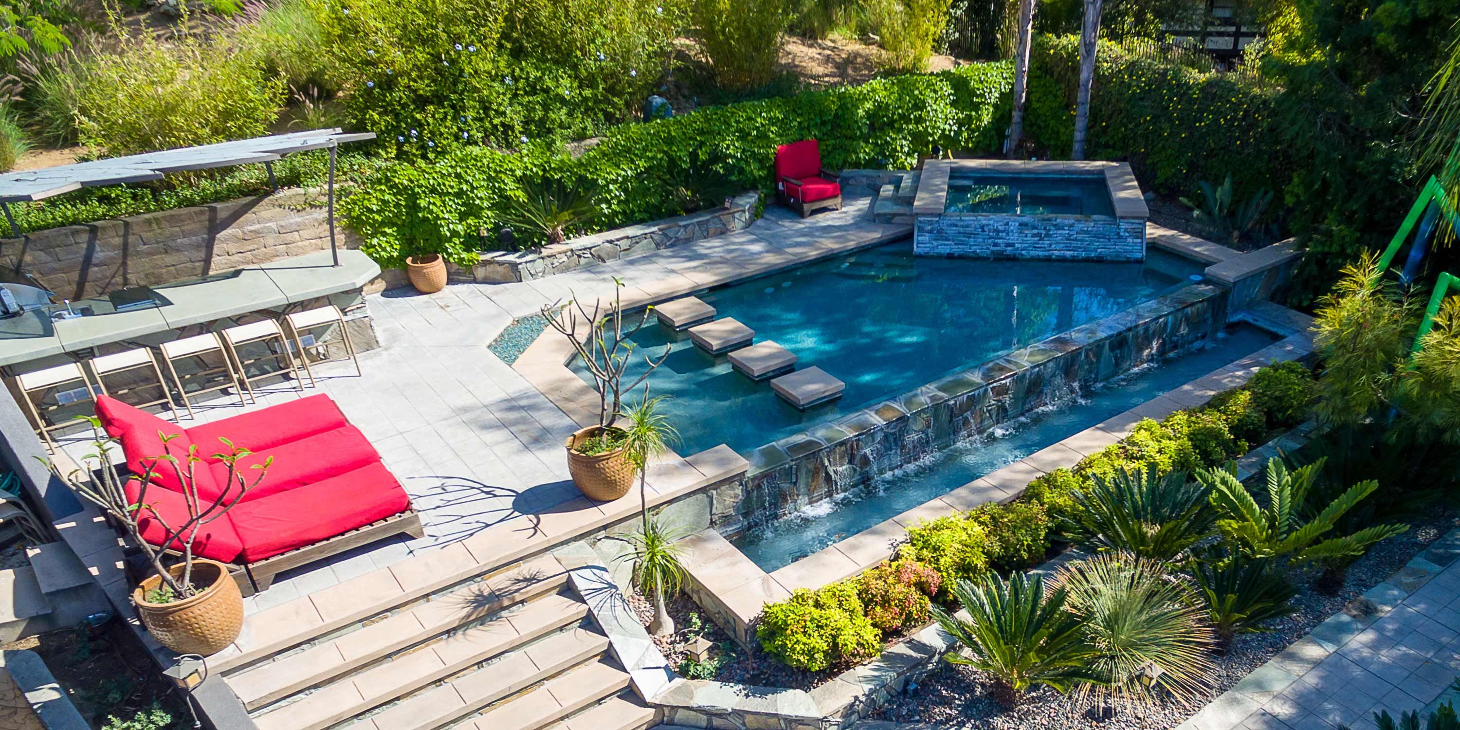 aerial view of california yard with red chairs and pool